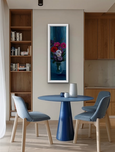 Modern kitchen with a blue dining table and chairs, wooden shelves, and a floral painting on the wall.